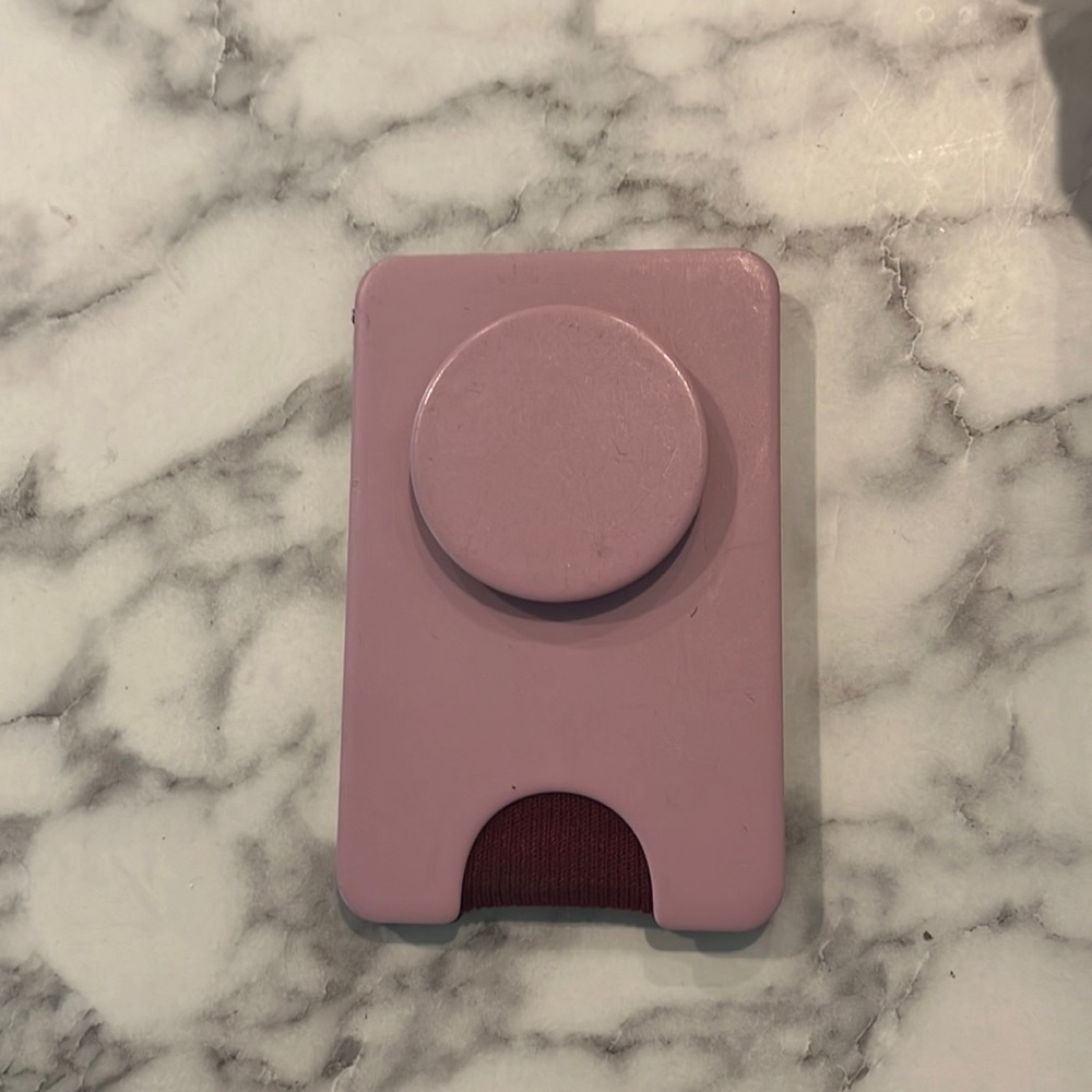Pink Popsocket MagSafe phone wallet.
